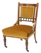 An Edwardian mahogany and marquetry nursing chair, with a padded back and seat, on turned legs with