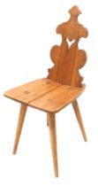 A continental elm hall chair, with a pierced shaped back, solid seat, on turned tapering legs.