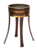 A 19thC mahogany and brass coopered jardiniere or celerette, with splayed legs, 78cm high, 46cm diam