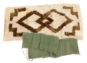 An animal fur rug, possibly goat, backed.