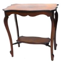 An Edwardian mahogany two tier table, with shaped top and splayed legs, 77cm wide.