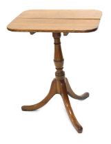 A 19thC oak occasional table, the rectangular tilt top with rounded corners on a turned column and t