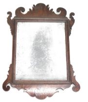 A small mahogany fret framed wall mirror, with distressed rectangular mirror plate, 43cm high, 30cm