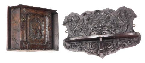 An oak wall shelf, carved with scrolls, berries, etc., 56cm wide, and a smaller carved oak corner ca