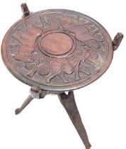 African tribal occasional table, the reversible top carved to one side with elephant, the other with