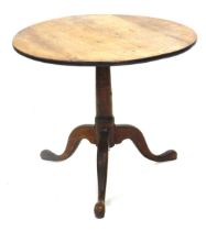 A George III oak occasional table, circular tilt top on a gun barrel turned column and tripod base,