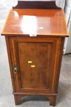 An Edwardian mahogany pot cupboard, with boxwood strung outer inlay and fitted back panel on bracket