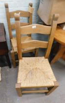 Two raffia and oak kitchen chairs.