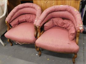 A pair of walnut framed an pink upholstered elbow chairs.