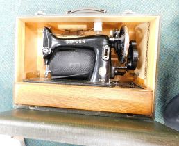 A cased Singer sewing machine.