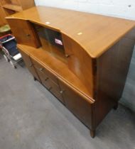 A teak sideboard, with two cupboard section and slide door above arrangement of three drawers and tw