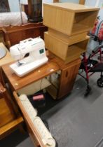 A beech effect sewing table enclosing a Brother Star 130E electric sewing machine, and two storage s