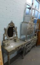 A silvered bedroom suite, in the French style, comprising dressing table, two two drawer bedsides, a