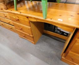 A pine office desk, chest of two short and three long drawers. (2)