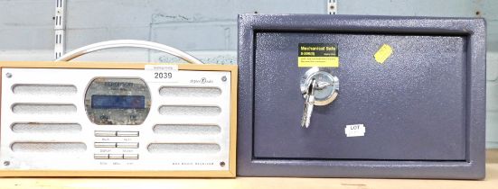 A Ferguson DAB digital radio, and a mechanical table top safe, with keys.