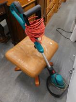 A Bosch corded electric strimmer and a tan leatherette stool. (2)