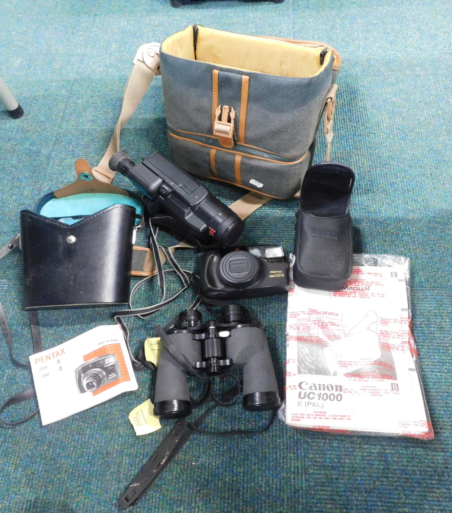 A group of camera equipment, comprising a Canon camcorder, Pentax camera, and a set of binoculars. (