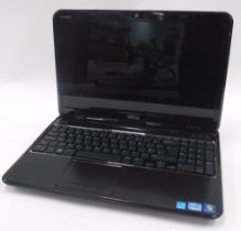 A Dell Inspiron laptop with charger.