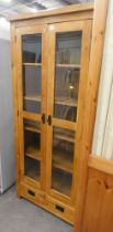 An oak display cabinet, with two glazed doors and fitted shelves, internal section with two lower dr