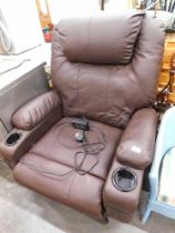 A brown leatherette electric reclining chair.