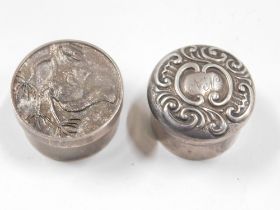 Two white metal pill boxes, comprising a Queen Elizabeth II silver pill box, with squirrel and acorn