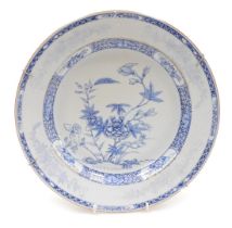 A Qing Dynasty last 18thC blue and white porcelain dish, decorated in tones of blue with flowers wit