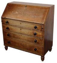 A George III oak bureau, with a later mahogany refitted interior, over four long graduated drawers,