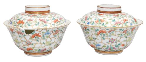 A pair of 20thC Chinese famille rose porcelain rice bowls and covers, decorated with flowers on a gi