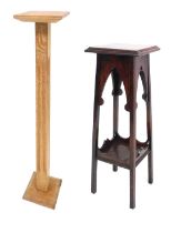 An early 20thC carved oak candle stand, raised on an outswept square channelled column over a square