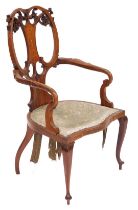 An Edwardian mahogany and inlaid carver chair, with a pierced and foliate scroll back, the splat inl