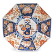 A Meiji period porcelain Imari dish, of octagonal form, decorated centrally with an urn of flowers,