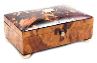 A 19thC tortoiseshell casket, with white metal inlay, raised on four turned bone feet, 10.5cm wide.