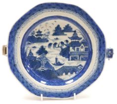 A 19thC Chinese blue and white porcelain warming plate, of octagonal form, decorated with a river la