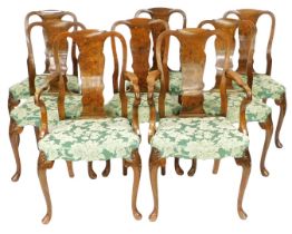 A set of George II style walnut dining chairs, with vase shaped splats, overstuffed seats in green f