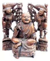 A late 19thC Chinese hardwood carving of a Buddha, seated on a lotus flower, 33cm high, and a pair o