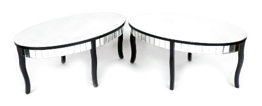 A pair of modern glass and ebonised coffee tables, each with an oval top above a glass panelled frie