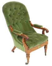 A Victorian mahogany spoon back armchair, upholstered in button back green draylon, raised on turned