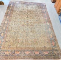 A Kashan silk cream ground rug, the central rectangular field decorated with flowers and scrolling l