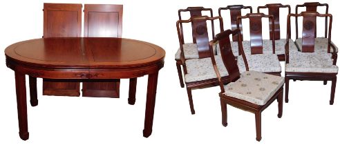 A Chinese hardwood oval dining table, with two additional leaves, raised on square legs and spade fe