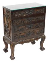 An Anglo Indian hardwood carved chest, carved with elephants in the jungle, having four long drawers