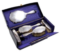A George V silver backed six piece dressing table set, for W Batty & Sons Limited, Manchester and Li