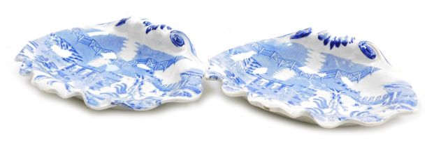 A pair of early 19thC blue and white pottery dishes, of scallop shell form, chinoiserie decorated, 1