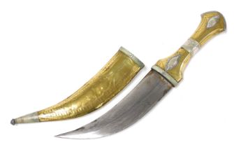 A Yemeni Jmbiya dagger, brass and silver, with an engraved steel blade, with scabbard, 30cm long.