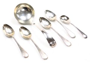 A George V silver cream ladle, Sheffield 1928, four silver coffee spoons, Sheffield 1919, and a Vict