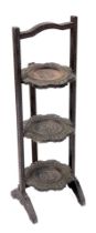 An early 20thC Anglo Indian hardwood three tier cake stand, carved with flowers and leaves, 81.5cm h
