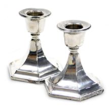 A pair of George V loaded silver candlesticks, of hexagonal form, Chester 1920, 14.20oz all in, 9cm