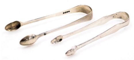 A pair of Georgian silver sugar tongs, with acorn terminals, and a pair of Victorian silver sugar to