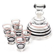 A mid century European cut glass liqueur set, decorated with red and silver lustre bands, comprising