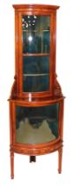 A late Victorian mahogany bow fronted corner display cabinet, the recessed upper section with an out