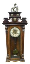 A late 19thC Continental mahogany cased wall clock, circular brass dial embossed with flowers, with
